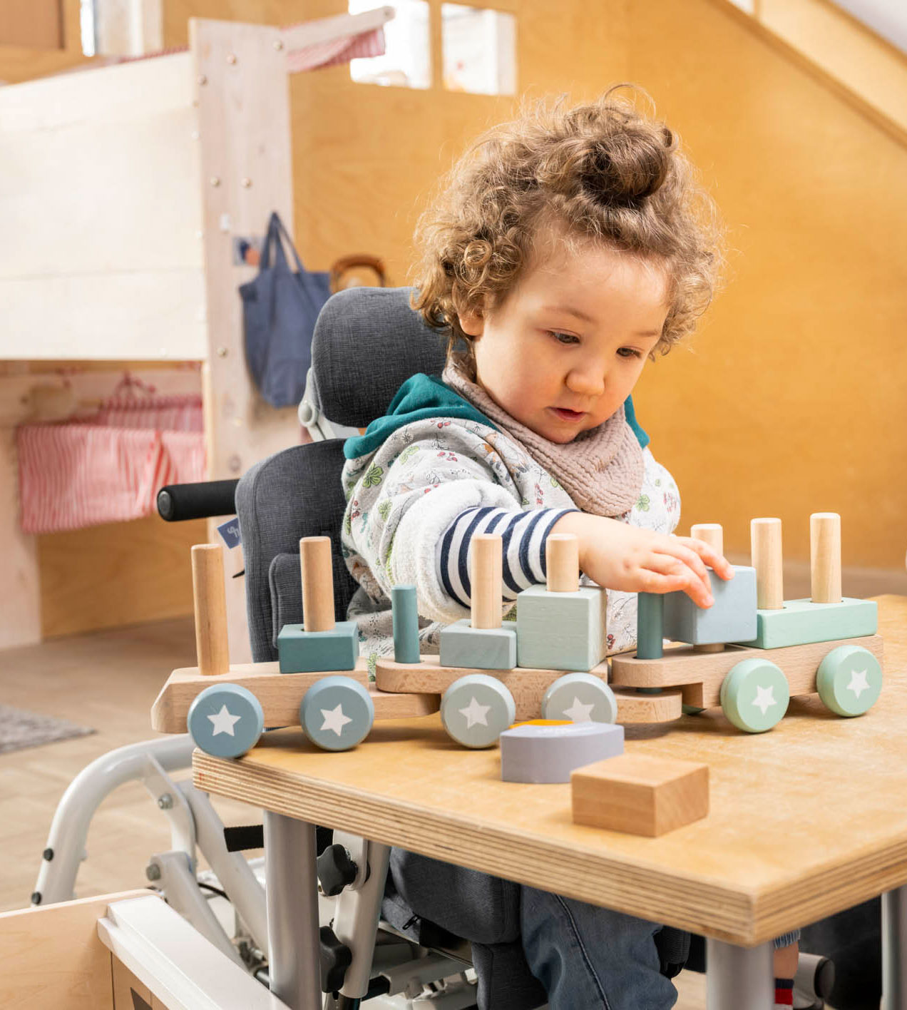 Child with a disability plays in a Schuchmann therapy chair